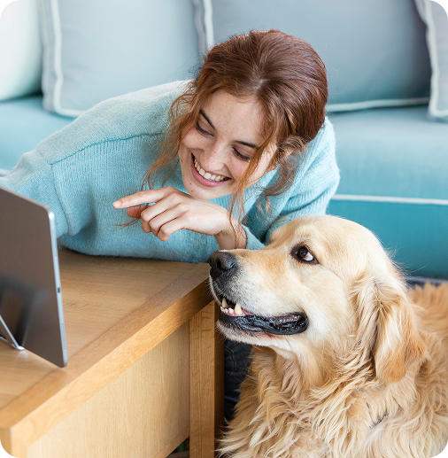 image of a woman and a dog smiling at a tablet