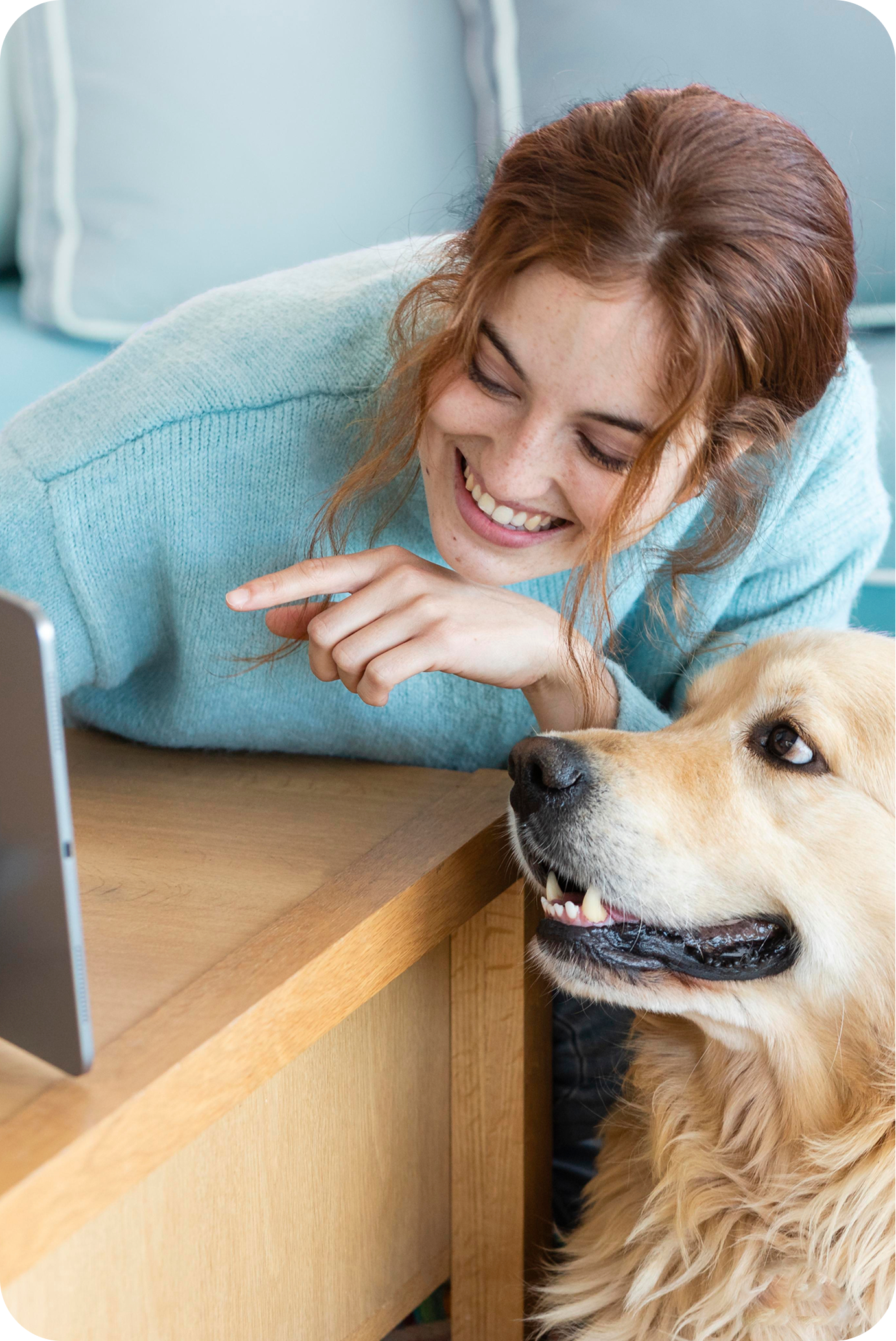 image of a woman and a dog smiling at a tablet