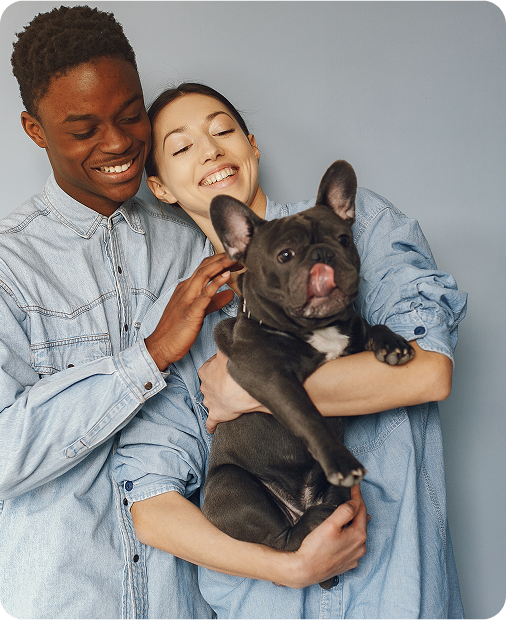 image of a happy couple holding a dog