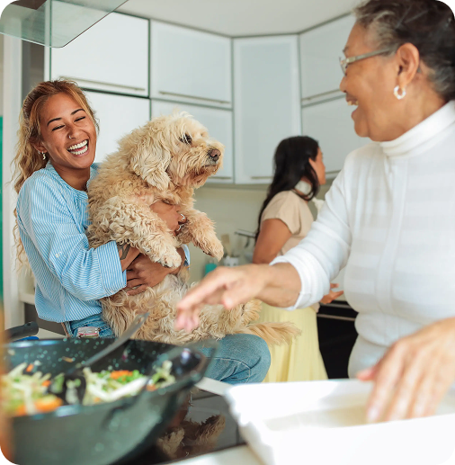 image of a happy family in the kitchen with their fluffy brown dog